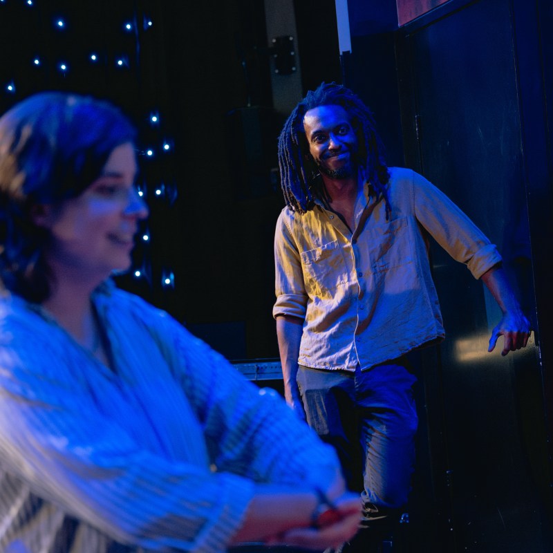 People in conversation with a starry backdrop; a smiling person leans against a door frame.