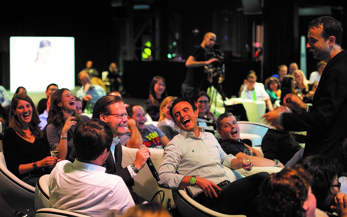 Andrew workshop flip Joe Hachem et al. sitting at a table in front of a crowd