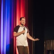 a man standing in front of a curtain