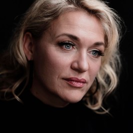 a woman who is smiling and looking at the camera