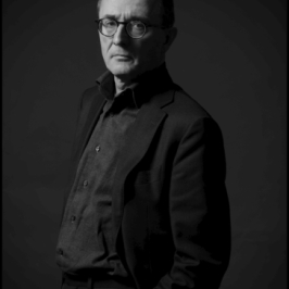 Julien Gracq standing in a dark room