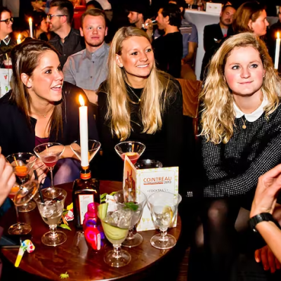 a group of people sitting at a table with wine glasses