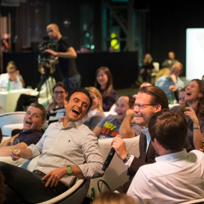 A group of people laughing and enjoying at Boom Chicago