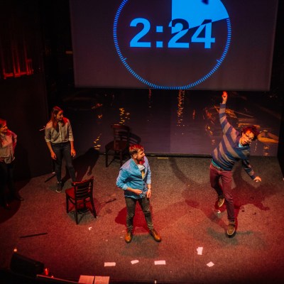 a group of people playing instruments and performing on a stage
