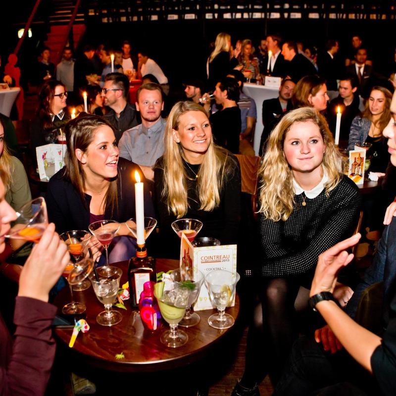A group of women sitting at a table with wine glasses