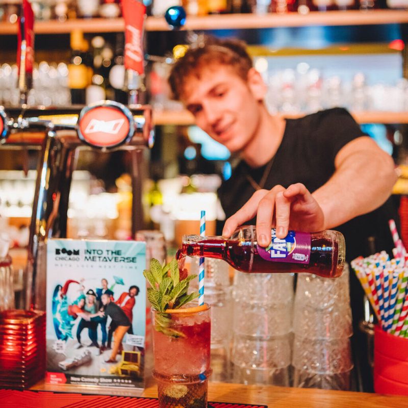 A bartender serving a cocktail