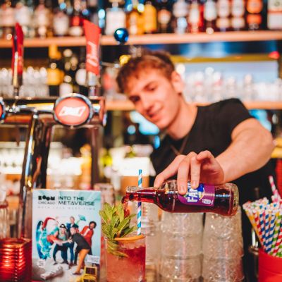 A bartender serving a cocktail