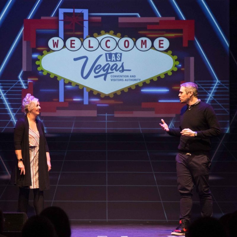 Stacey Smith and Matt Castellvi standing on a stage in front of a crowd
