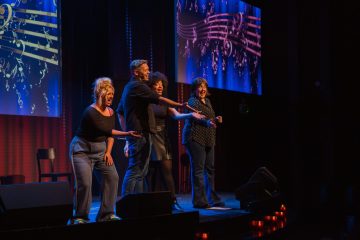 a group of people standing in front of a stage