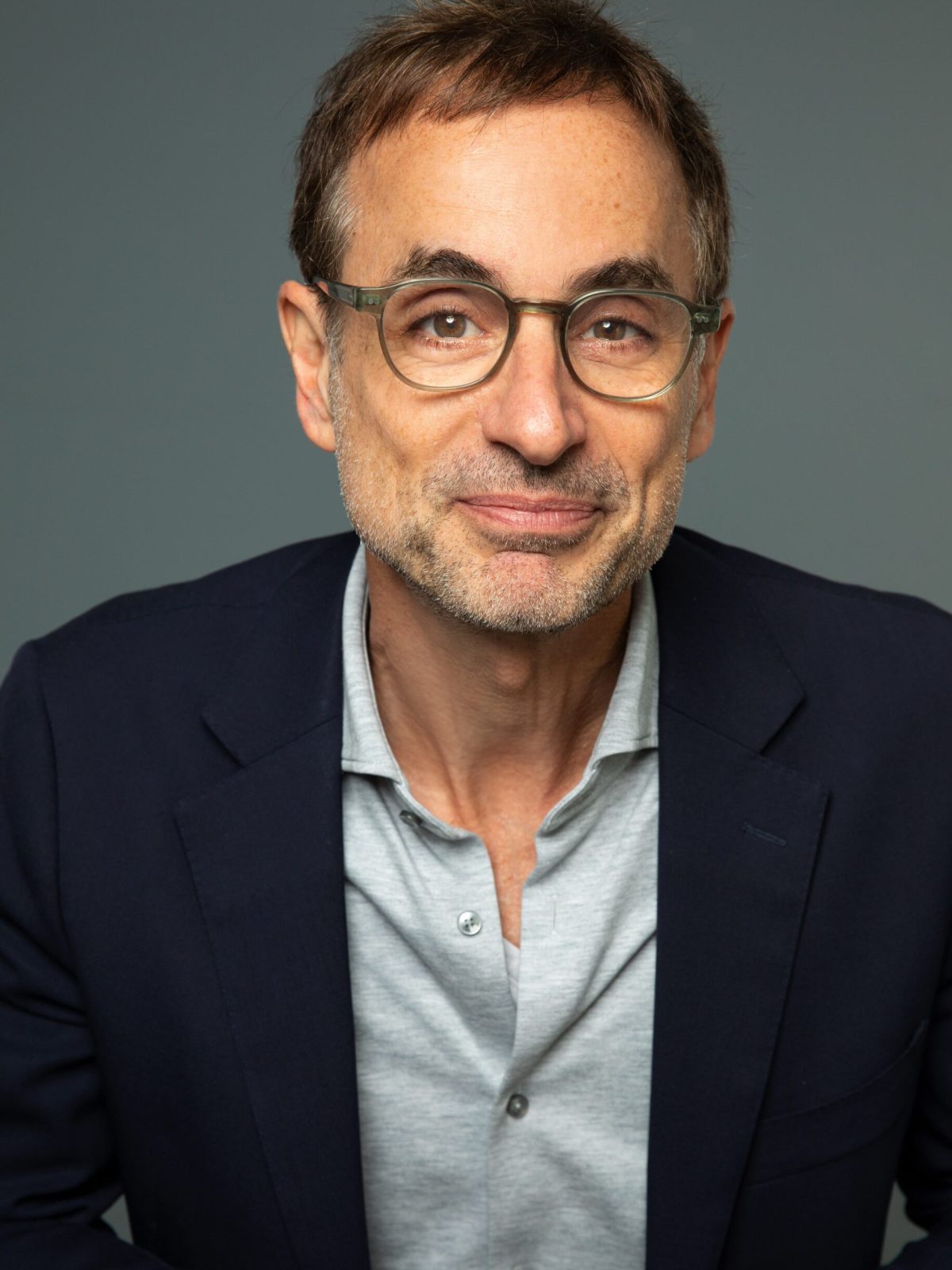 a man wearing glasses and looking at the camera