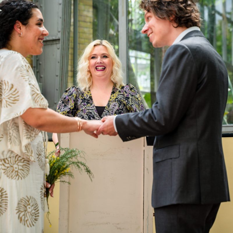 a man and a woman standing next to a window