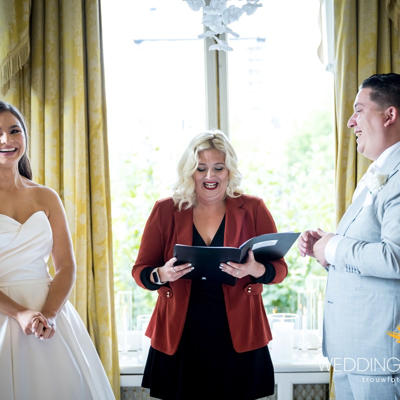 a man and a woman standing in front of a window