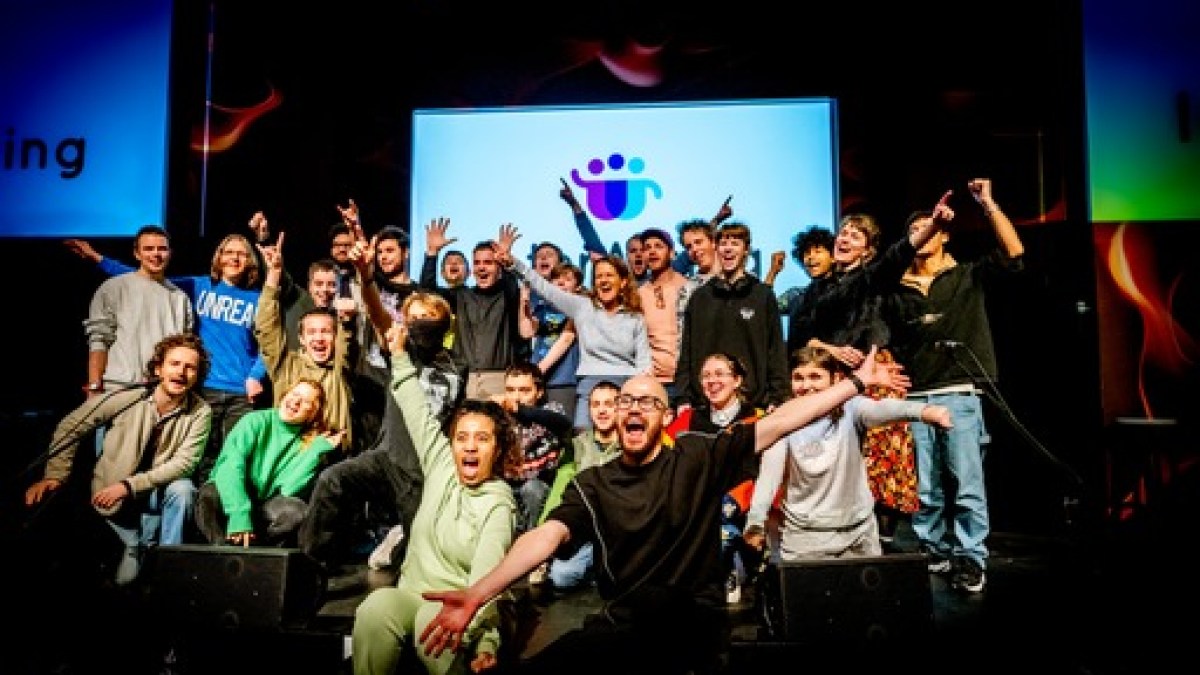 a group of people on a stage in front of a crowd