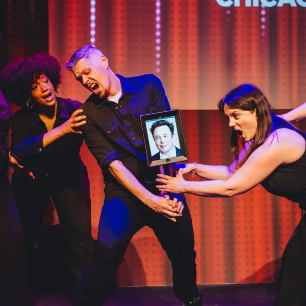 Elon Musk et al. that are standing in front of a stage