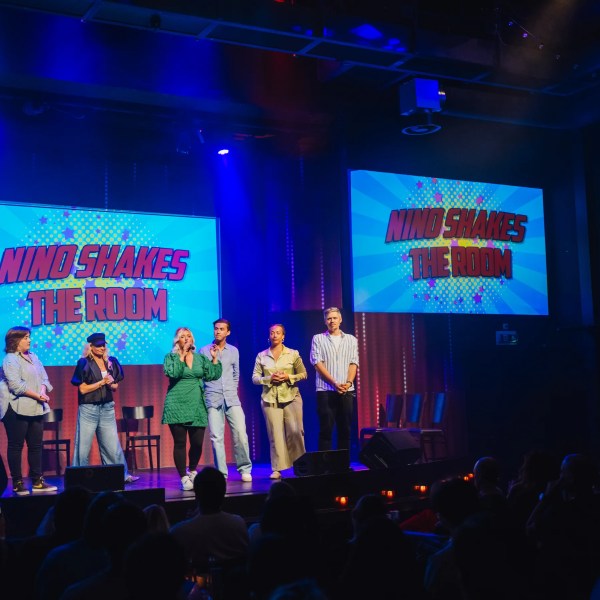 a group of people on a stage in front of a crowd