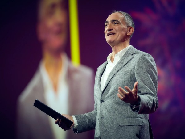 a person wearing a suit and tie talking on a cell phone