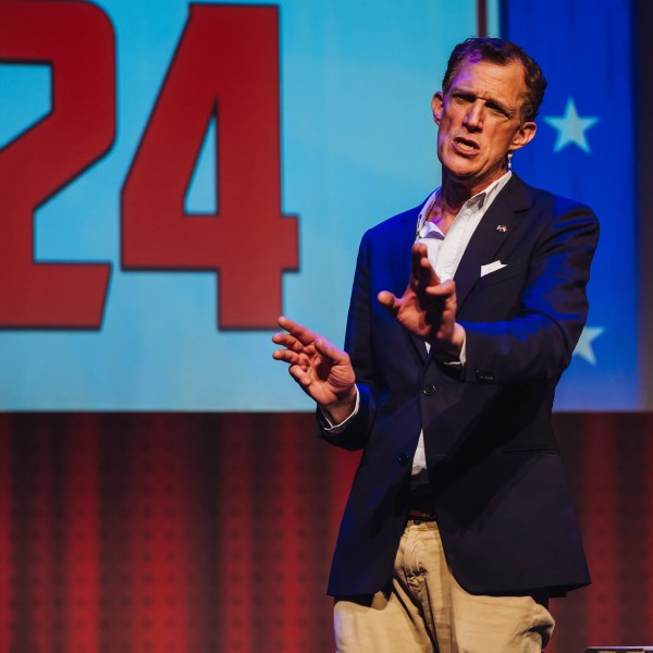 a person wearing a suit and tie talking on a cell phone