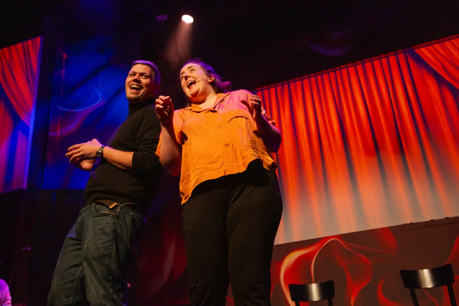 a person standing on a stage playing a video game