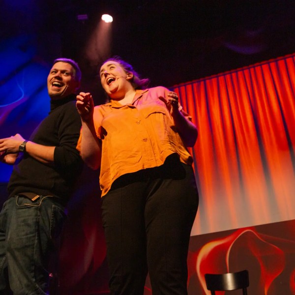 a person standing on a stage playing a video game