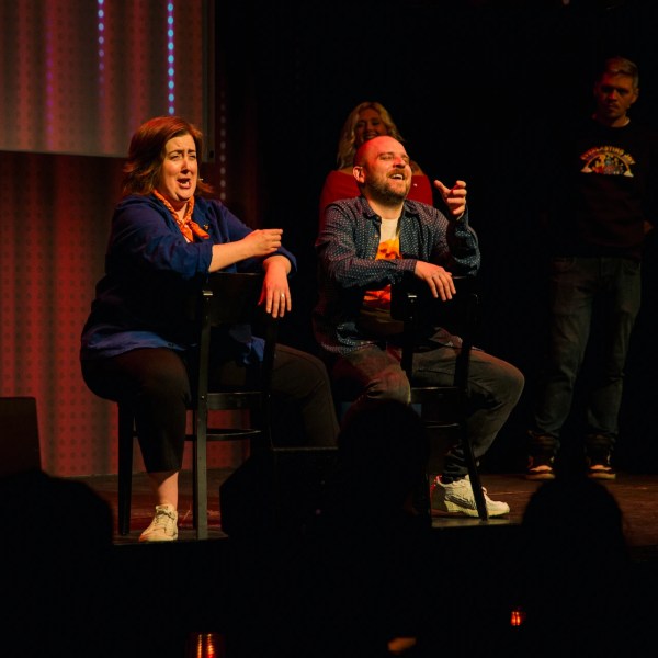 a man and a woman sitting on a stage