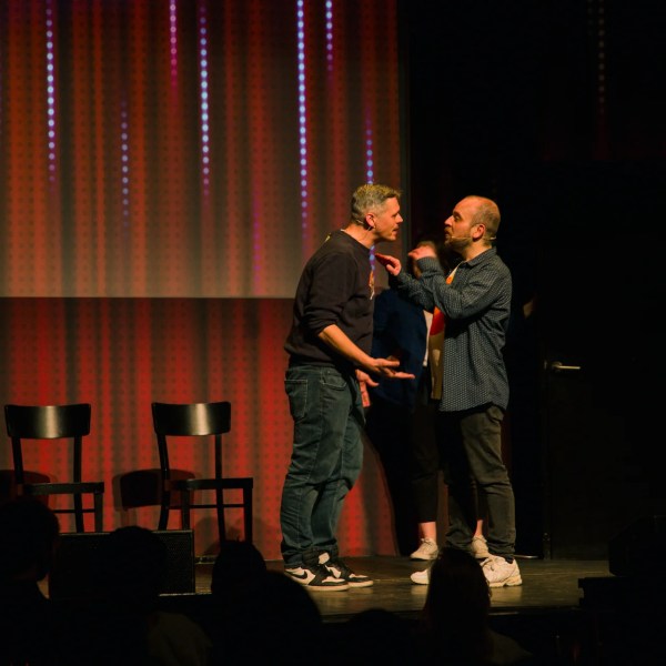 a man standing in front of a curtain