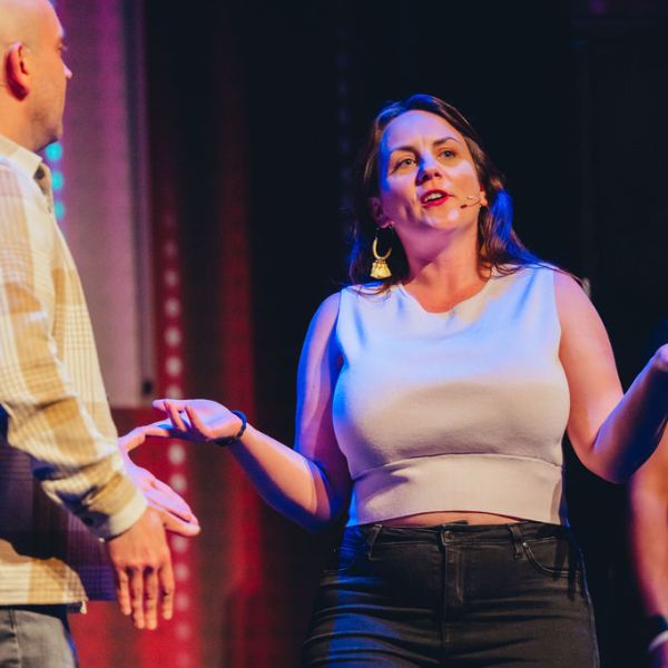 a couple of people standing on a stage