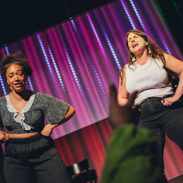 a person standing on a stage posing for the camera