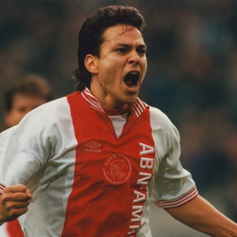 a man holding a football ball