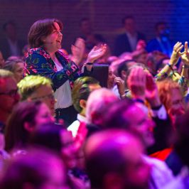 a group of people on a stage in front of a crowd