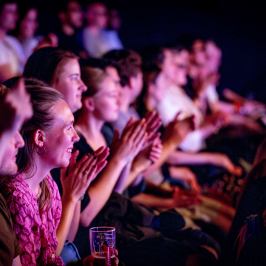 a group of people on a stage in front of a crowd