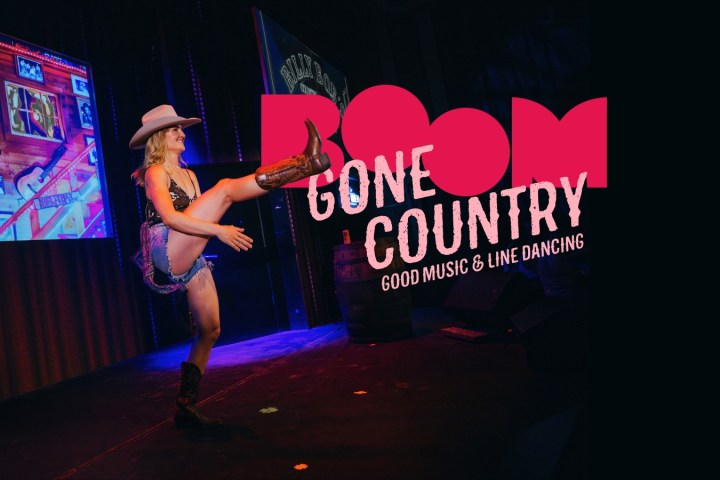 Cowgirl dancing on stage, 'Gone Country' text, lively ambiance.