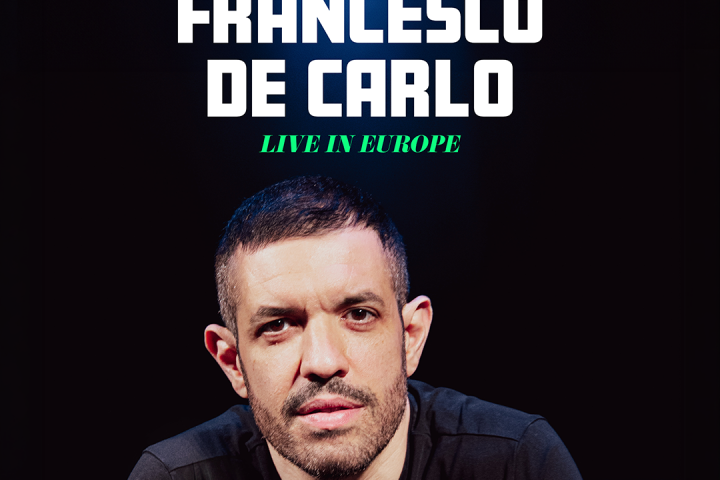 Man seated, promoting Francesco De Carlo comedy show, Amsterdam, October 7.